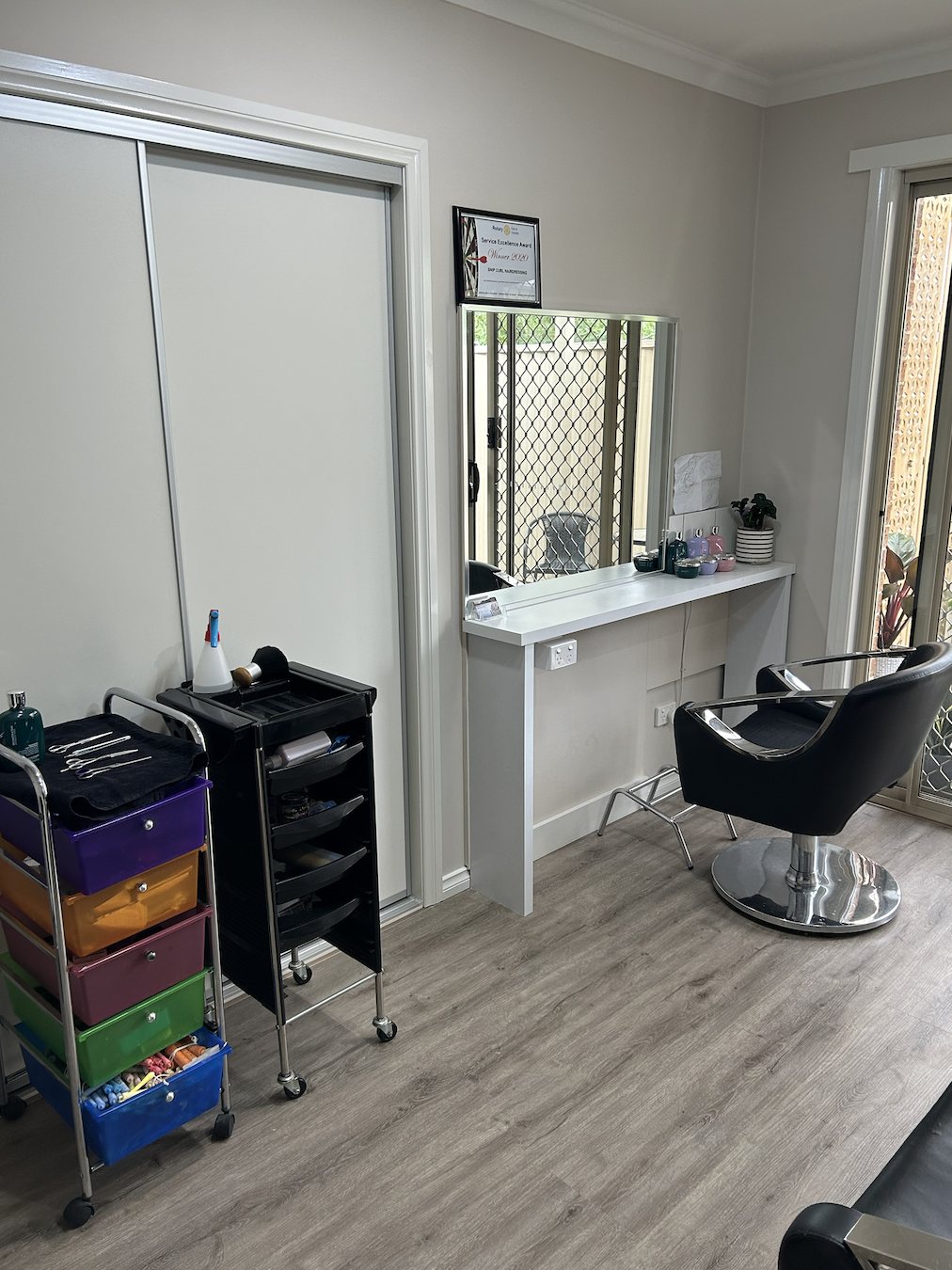 Inside the Snip Curl home salon: styling chair, mirror and colour trolley
