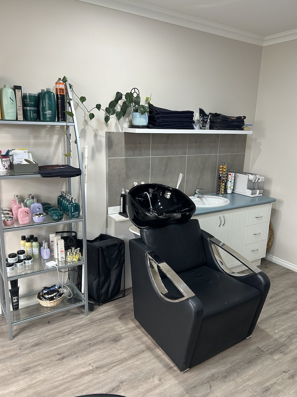The backwash basin and product shelves in the salon